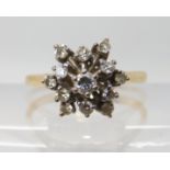 A bright yellow metal diamond snowflake cluster ring, head size 13.2mm, set with estimated approx