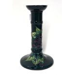 A Moorcroft Finches and Berry candlestick on green ground, 21cm high Condition Report: Available