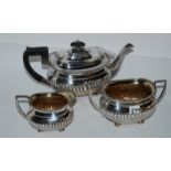 A three piece silver tea service, Sheffield 1929 with half ribbed body and gadrooned border, 1250gms