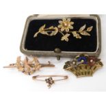 A bright yellow metal flower brooch weight 3.6gms, two 9ct gold brooches weight combined 3.6gms, and