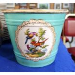 A continental ceramic jardiniere with painted decoration of colourful birds on a turquoise ground