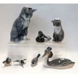 A Royal Copenhagen figure of a cat. no 055, a Great Crested Grebe no 3263, a duck no 1924, a pair of