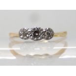 An 18ct gold and platinum three stone diamond ring, diamonds combined 0.15cts, finger size S, weight