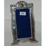 A silver mounted photo frame, Birmingham 1911, 27cm x 17cm, aperture 18.5cm x 9cm (some damage to