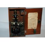 A cased black lacquer microscope by Prior & Co and cased slides Condition Report: Available upon