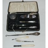 A cased silver manicure set, Birmingham 1934 and a silver handled buttonhook Condition Report: