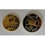 A Hong Kong 1994 ten dollar gold/silver coin, 22ct centre, silver inner with 9ct outer band with a