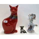 A Lladro figure of a comical dog singing, a Poole pottery flambe cat and a small bronze of a