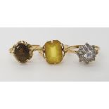 A 9ct gold smoky quartz ring size O, a cz cluster ring size P1/2 and a 9ct yellow glass ring size P,