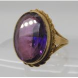 A 9ct gold faux amethyst set ring size N, weight 7.6gms Condition Report: Available upon request