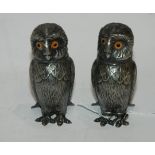 A pair of white metal figures of owls with glass eyes, 10cm high Condition Report: Available upon
