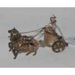 A miniature silver model of a three-horse chariot and driver, 9cm long bearing import marks,
