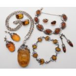 A collection of silver and white metal mounted amber jewellery to include an unusual bracelet in the