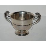 A silver bowl, London 1905 of circular form with twin scrolling handles, terminating in mythical