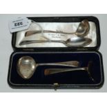A lot comprising a cased silver spoon and pusher, a silver teaspoon and a silver sauce ladle,