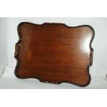 A mahogany two-handled shaped tea tray with gallery border, 57cm wide Condition Report: Available