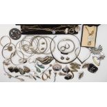 A collection of silver and white metal jewellery to include Mexican silver items, bangles and