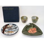 A Moorcroft Woodside Farm circular dish 12cm diameter (boxed), two sake cups, one decorated with