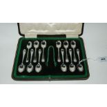 A cased set of twelve silver coffee spoons with tongs, Sheffield 1916 Condition Report: Available