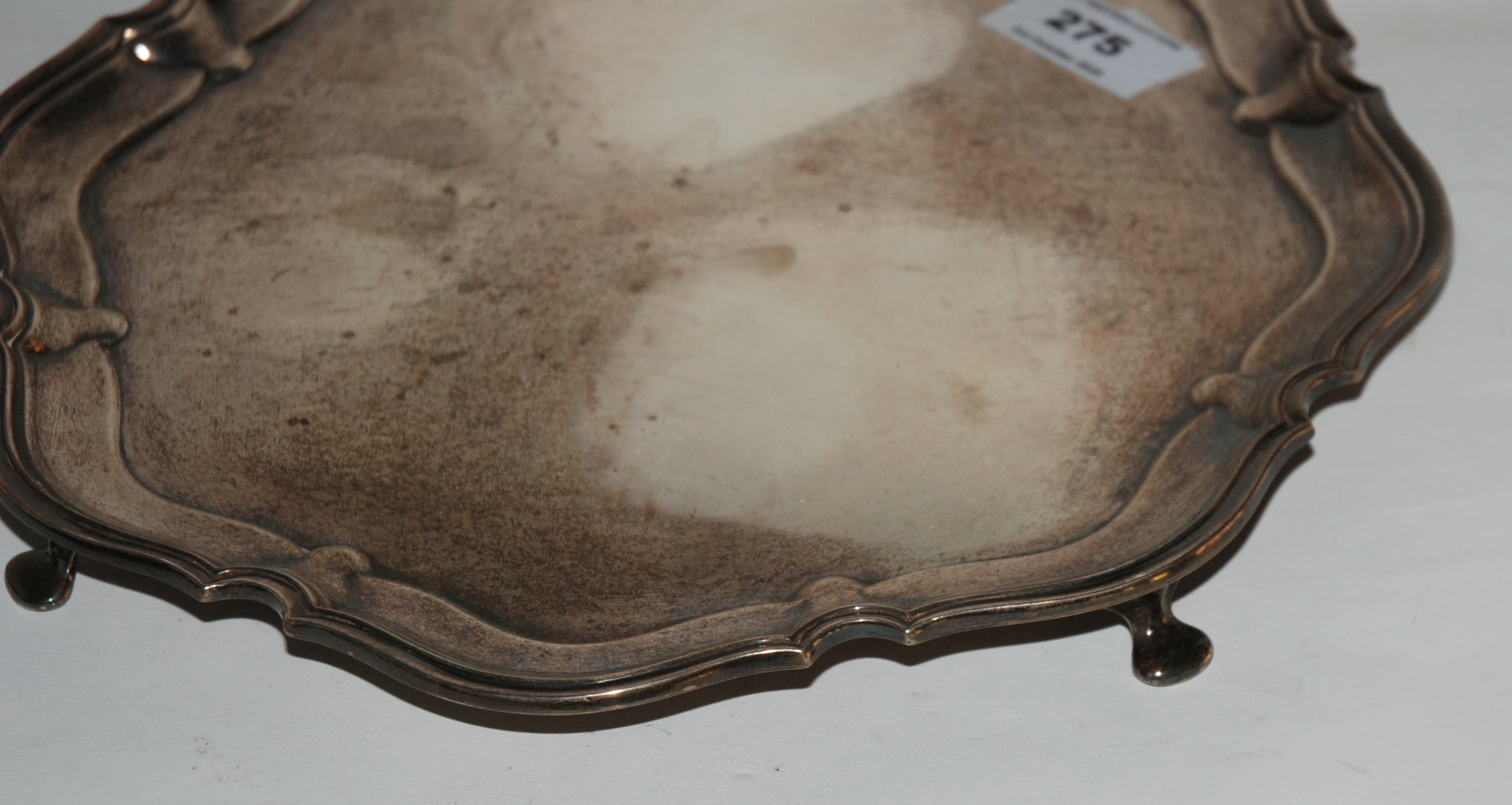 A silver card tray, Sheffield 1930 of circular form with scalloped edges on four out swept feet, - Image 2 of 2