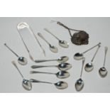 A lot comprising assorted silver coffee spoons, a pair of tongs, decanter label, Birmingham 1956,