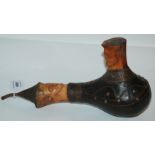 An unusual tribal pipe with carved bone heads, 34cm wide Provenance - The Estate of the late Tom