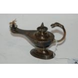 A silver oil lamp modelled as an Aladdin's lamp, 14cm long, 117gms Condition Report: Available