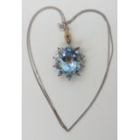 A 9ct yellow gold checkerboard cut blue topaz pendant with a 9ct white gold chain, length of pendant