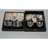 A lot comprising two cased pairs of silver napkin rings, Birmingham 1937 and Sheffield 1919,