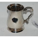 A silver tankard unclear Georgian London marks of plain baluster form with scrolling handle, 10cm