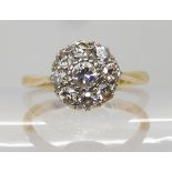 An 18ct gold and platinum diamond cluster ring, set with estimated approx 0.35cts of old cut