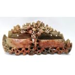 A carved soapstone brush holder decorated with fruiting trees Condition Report: Available upon