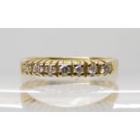 A bright yellow metal diamond set half eternity ring, size P1/2, weight 2.8gms diamond content