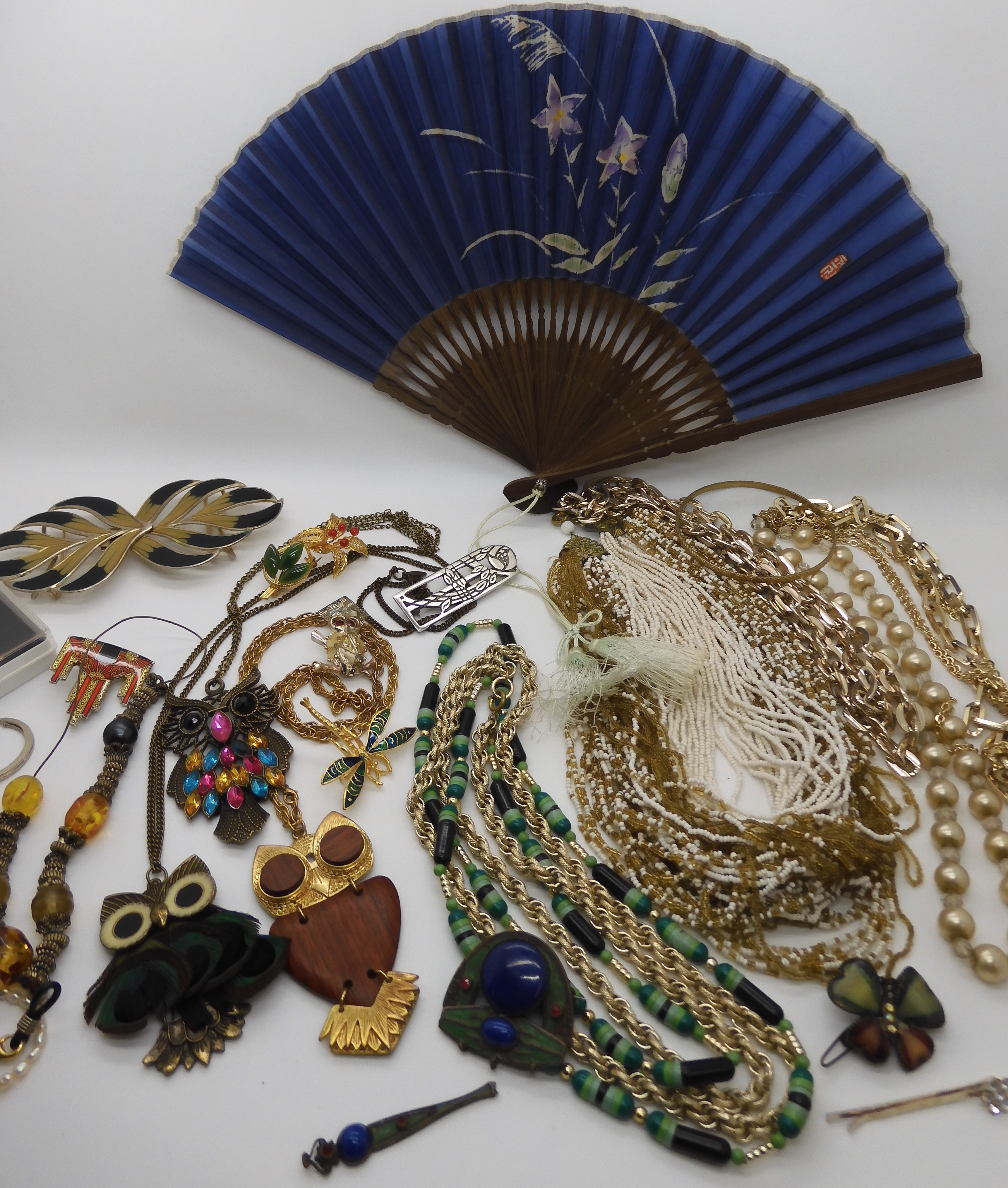 A multi bead necklace, owl pendants and other items Condition Report: Not available for this lot