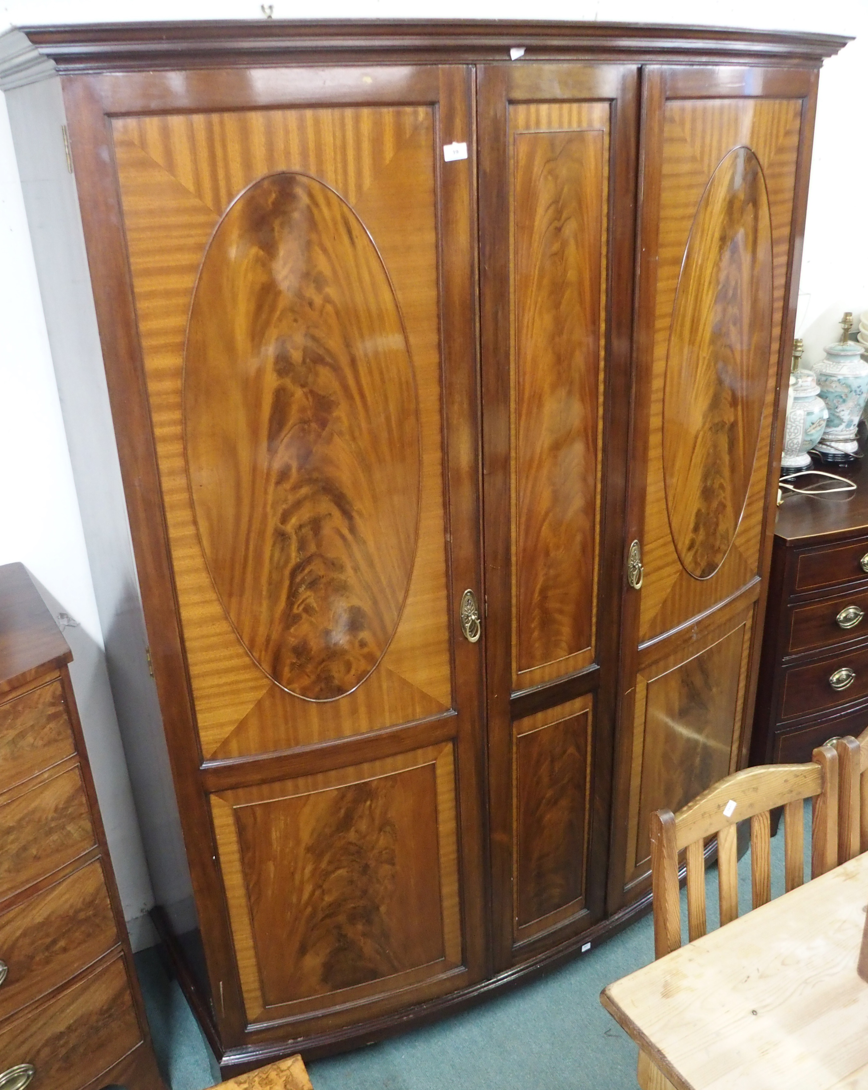 A mahogany two door bow front wardrobe, 206cm high x 165cm wide Condition Report: Available upon
