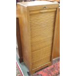 An oak filing cabinet with tambour front, 115cm high x 46cm wide Condition Report: Available upon