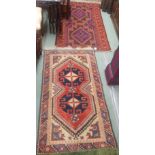 An Eastern rug with two central lozenges, 150cm x 84cm and another Eastern rug with geometric design