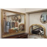 A gilt overmantle mirror, 66cm high x 115cm wide, a gilt wall mirror, 105cm high x 135cm wide (2)