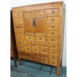 A Chinese cabinet with two cupboard doors with multiple drawers, 174cm high x 124cm wide Condition