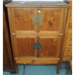A modern Chinese cabinet with two doors over two lower doors with brass fittings , 168cm high x
