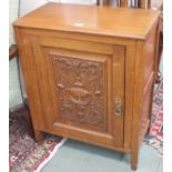 An oak cabinet with single carved door, 82cm high x 65cm wide Condition Report: Available upon