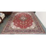 A red ground Keshan rug with central medallion and matching spandrels, 340cm x 247cm Condition