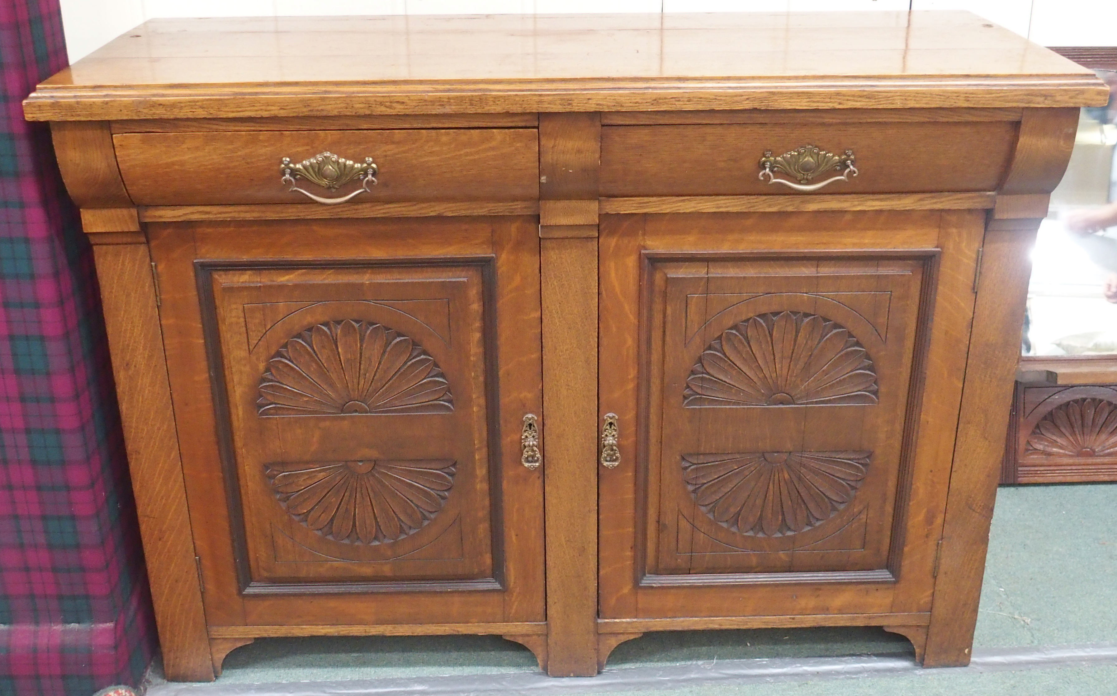 An oak sideboard with two drawers over two cupboard doors (mirror back def), 100cm high x 137cm wide