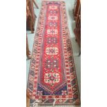 A red ground Eastern runner with geometric design, 304cm x 74cm Condition Report: Available upon