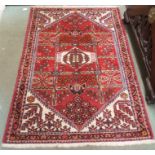 A red ground Eastern rug with geometric design, 152cm x 106cm Condition Report: Available upon