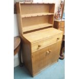 A small oak dresser with open shelves on a base with two drawers, 136cm high x 76cm wide Condition