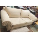 A modern light three seater sofa on turned legs and brass castors Condition Report: Available upon