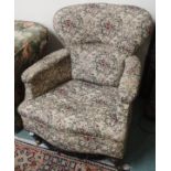 An upholstered armchair with tuned legs and brass castors Condition Report: Available upon request