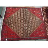 A red ground Eastern rug, 140cm x 122cm Condition Report: Available upon request
