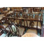 A set of twelve Chippendale style dining chairs with leather seats (four carvers and eight